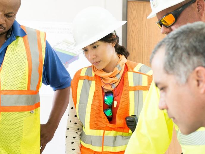 Female Keller project manager talking with colleagues